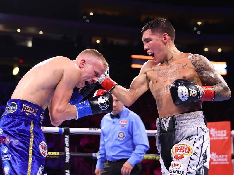 Liam Wilson (left) feels the full force of WBO super-featherweight rival Oscar Valdez. (HANDOUT/TOP RANK)